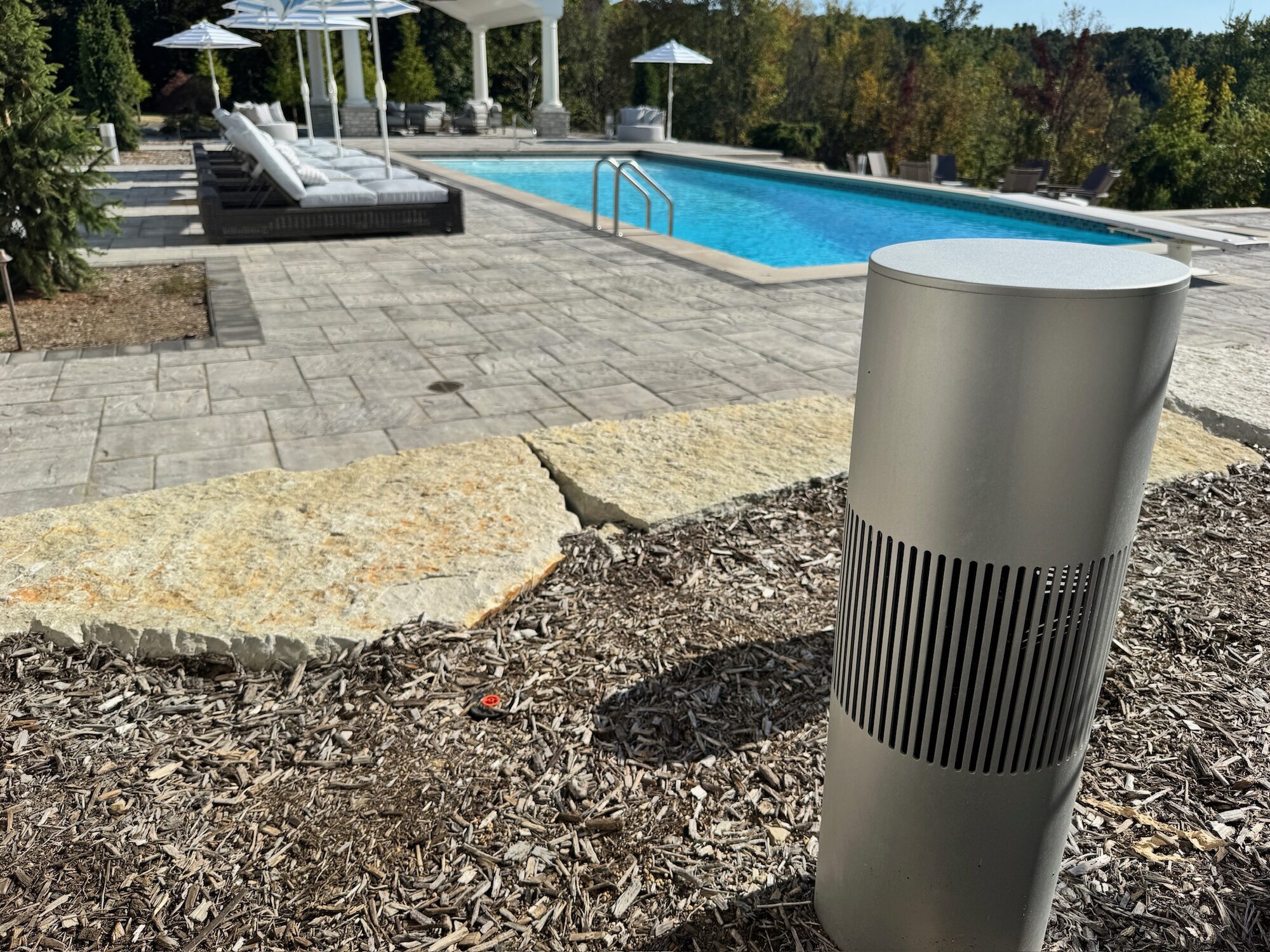 Bollard landscape speaker beside a pool at a luxury home